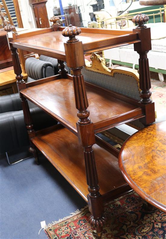 A Victorian mahogany rectangular three tier buffet, on reeded and turned supports and similar legs with brass W.4ft 4in.